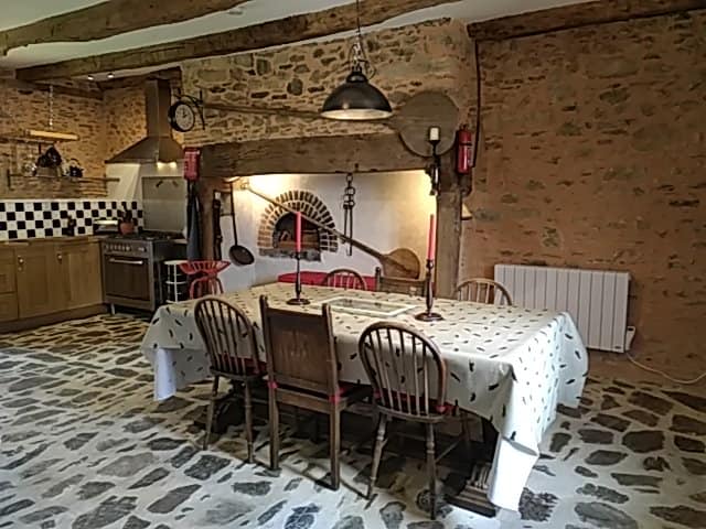 View of the large kitchen table and huge fireplace
