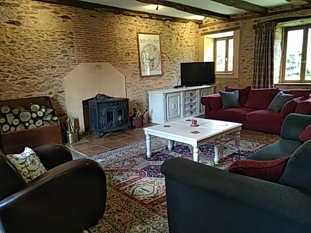Views of the spacious Gite lounge showing the magnificent woodburner